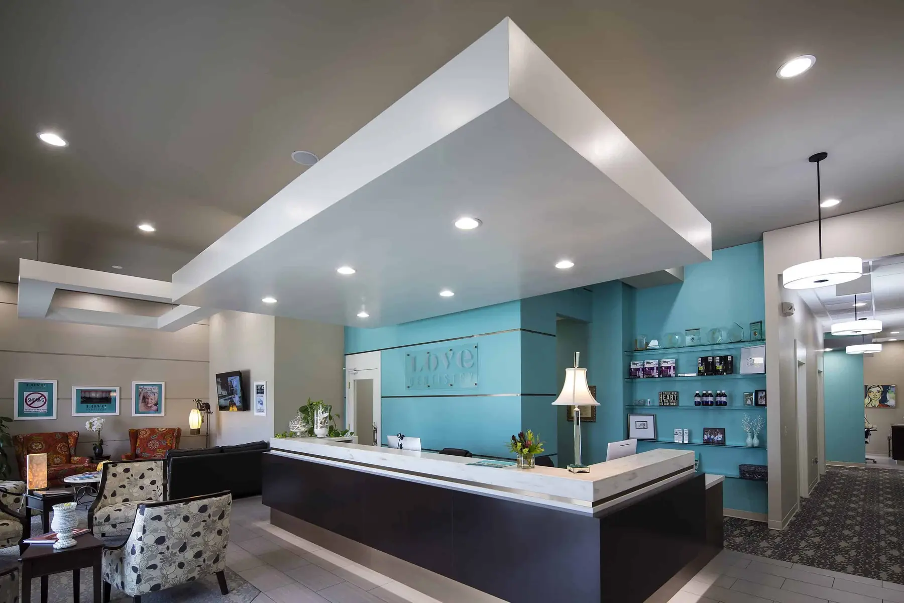The bright Love Sleep reception area with a teal accent wall.